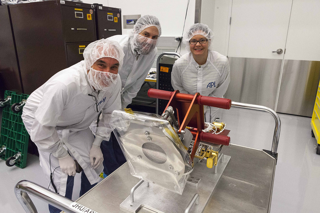Getting ready to put the Solar Probe Cup (SPC) on the Parker Solar Probe (PSP)! Pictured left to right: Chris Scholz (University of California Berkeley), Anthony (Tony) Case (Smithsonian Astrophysical Observatory, SPC Instrument Scientist), Kelly Korreck (Smithsonian Astrophysical Observatory, SWEAP Head of Science Operations)