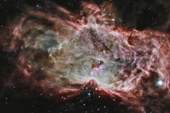 A star cluster in the center of the Flame Nebula about 1,400 light years from Earth.
